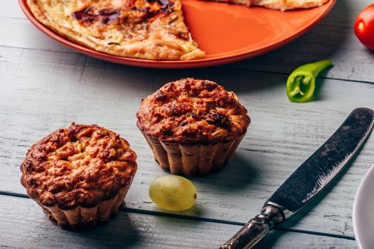 Homemade oatmeal muffins over light wooden surface