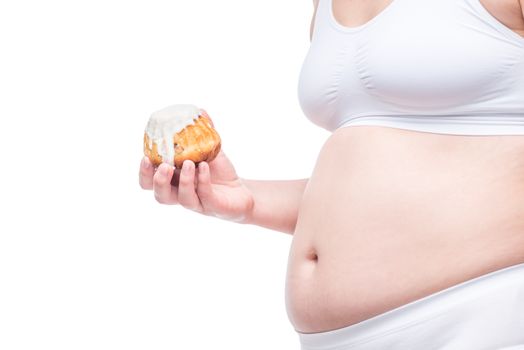 fat girl with a muffin in her hand in the underwear, belly closeup