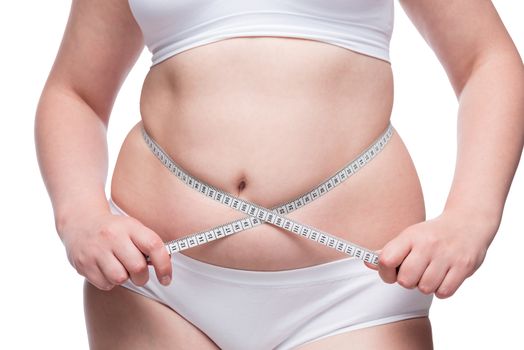 the concept of fighting obesity - fat belly close up covered with measuring tape