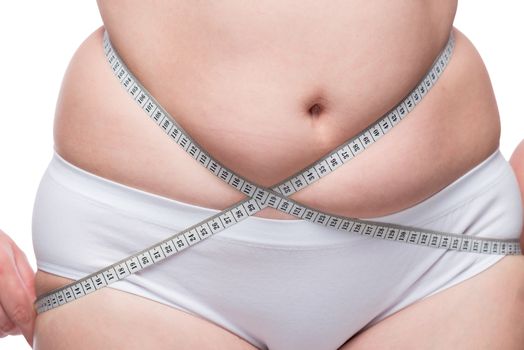 weight loss - fat belly close up covered with measuring tape