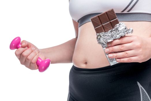 Woman with dumbbells and chocolate belly closeup