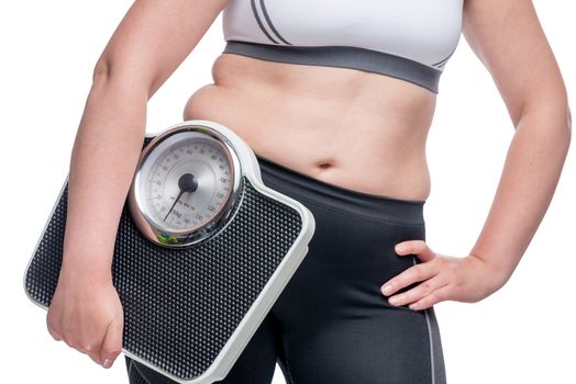 Concept photo of striving for the perfect figure, woman with weights, belly closeup