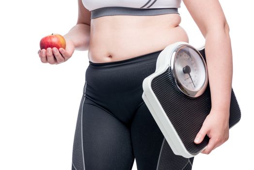 woman with scales and apple makes a choice in favor of sports and healthy eating concept photo