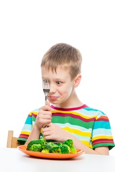 portrait of a boy with a plate of broccoli, shooting on a white background is isolated