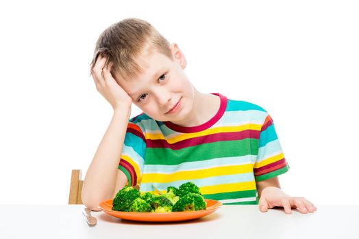 Child and a plate of broccoli, concept photo food and children