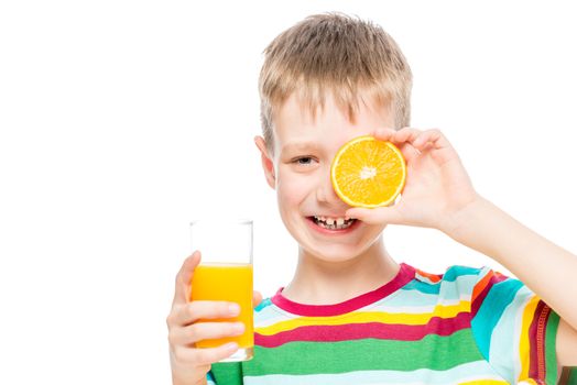 boy with a glass of fresh healthy juice and a slice of orange isolated portrait