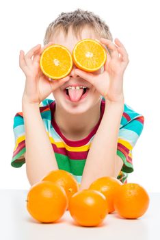 vertical portrait of a funny boy with oranges on a white background