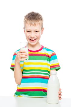 boy with a glass of milk on a white background, the portrait is isolated