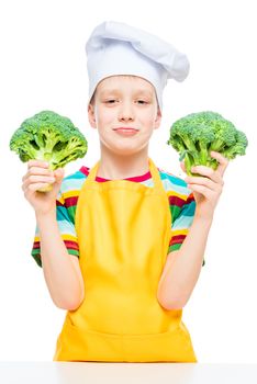 little cook in hat and apron with broccoli on white background isolated