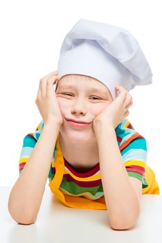 sad cook 10 years old in hat posing on white background