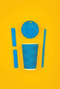 Close up one crimped disposable blue paper takeaway cup, plastic cap, two sugar sachets and drinking straw over vivid yellow background, flat lay, elevated top view, directly above