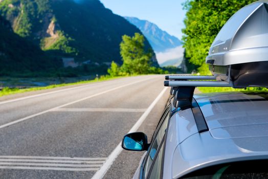 Picturesque mountains and the canyon of the Caucasus and the car with a roof rack, the landscape of Georgia