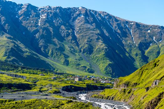 Gergeti Village on the background of the high Caucasus Mountains in Georgia