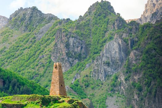 Tower of Georgia on the background of the high mountains of the Caucasus