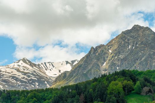 High mountains with remnants of snow on top in Georgia in summer, Caucasus