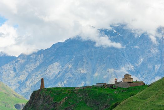 Georgian buildings on the background of high beautiful Caucasian mountains