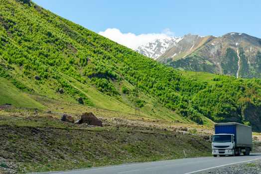 Wagon with a load on a mountain road in a picturesque place in the Caucasus