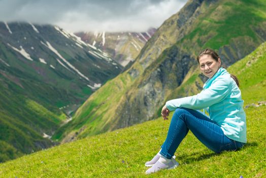 A woman admires the mountains in the campaign in the Caucasus