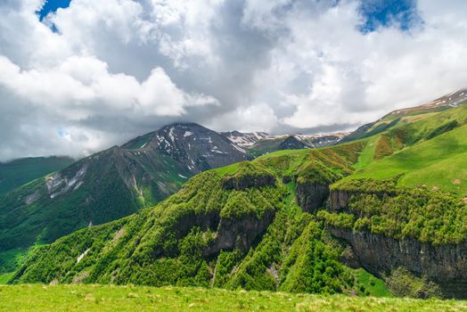 High mountain ranges of the Caucasus in June, snow on the peaks on a sunny warm day. Landscapes of Georgia