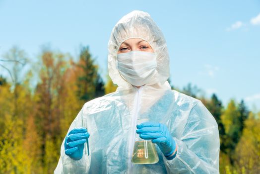 horizontal portrait of a chemist-researcher of a lake's water composition during an epidemic