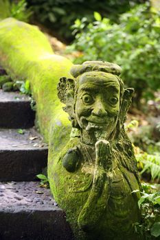 Balinese stone statue before a temple