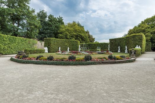 beautifull english garden with green plants and flowers , decoartion and water pond with  borders 