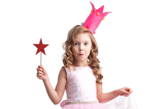 Beautiful little candy princess girl in crown holding star shaped magic wand and making a wish