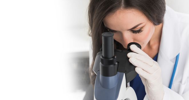 Female scientist looking through a microscope, white copy space for text