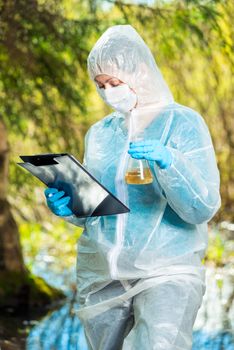 work of an ecologist in nature, research of contaminated water in a forest river