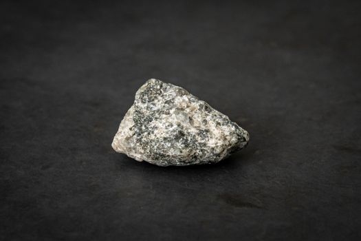 Small piece of the hardest kind of granite bed rock with its typical texture and color