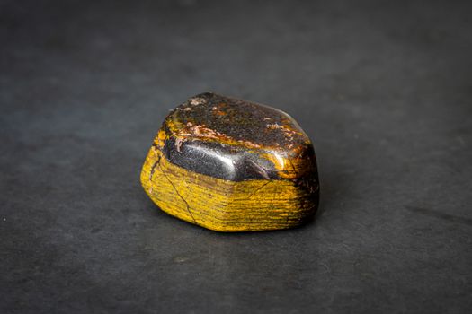 Tiger iron gemstone precious gem with shiny surface yellow and grey