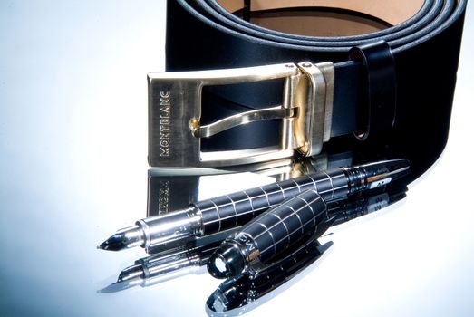 Leather belt and pen on a glass background