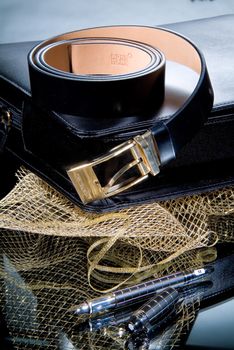 Leather belt and pen on a glass background