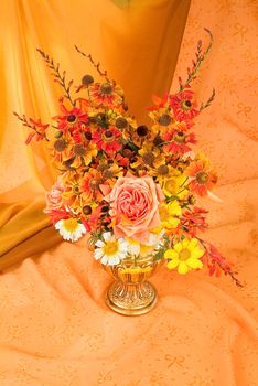 Still life with bouquet of flowers and accessories on a studio background