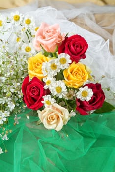 Still life with bouquet of flowers and accessories on a studio background