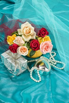 Still life with bouquet of flowers and accessories on a studio background