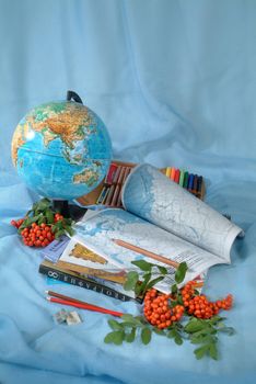 School books and accessories on a studio background