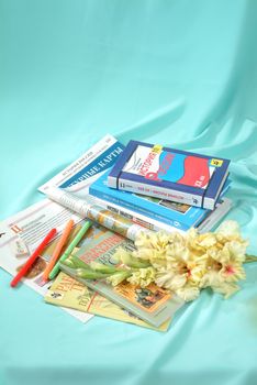 School books and accessories on a studio background