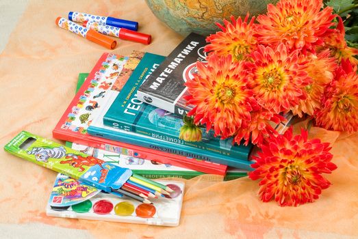 School books and accessories on a studio background