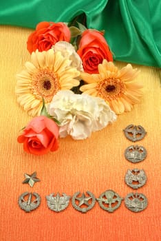 Metal Russian army emblems and flowers on textured background