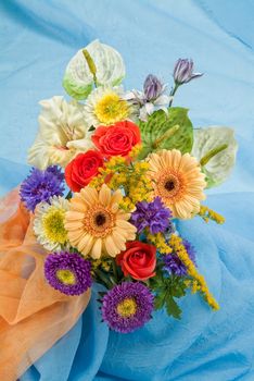 Still life with bouquet of flowers and accessories on a studio background