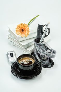 Office accessories and books on a studio background