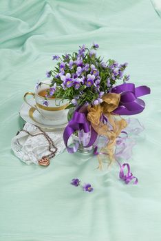 Still life with bouquet of flowers and accessories on a studio background