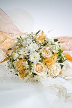 Still life with bouquet of flowers and accessories on a studio background