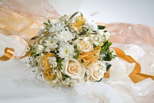 Still life with bouquet of flowers and accessories on a studio background