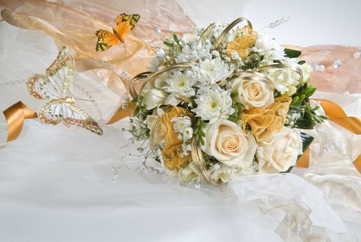 Still life with bouquet of flowers and accessories on a studio background