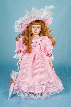 Doll dressed in retro style on a studio background