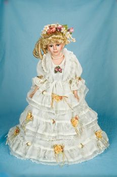 Doll dressed in retro style on a studio background