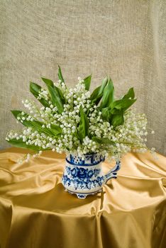 Still life with bouquet of flowers and accessories on a studio background