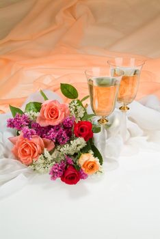 Still life with bouquet of flowers and accessories on a studio background